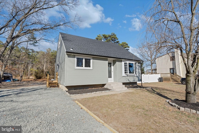 bungalow with fence and a shingled roof