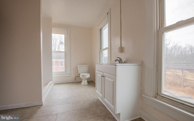 bathroom with vanity, tile patterned floors, toilet, and baseboards