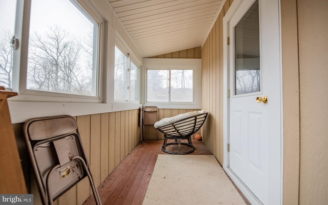 sunroom / solarium featuring vaulted ceiling