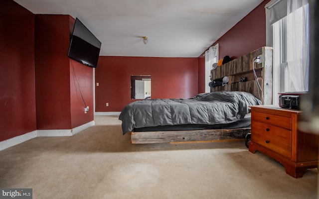 carpeted bedroom featuring baseboards