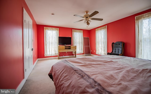 carpeted bedroom with baseboards and a ceiling fan