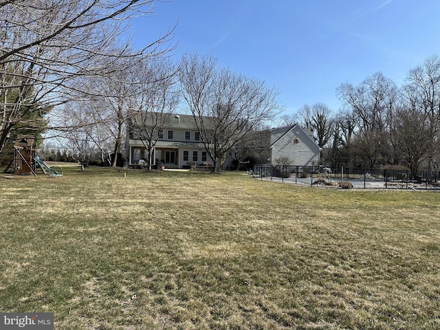 view of yard with a playground and fence