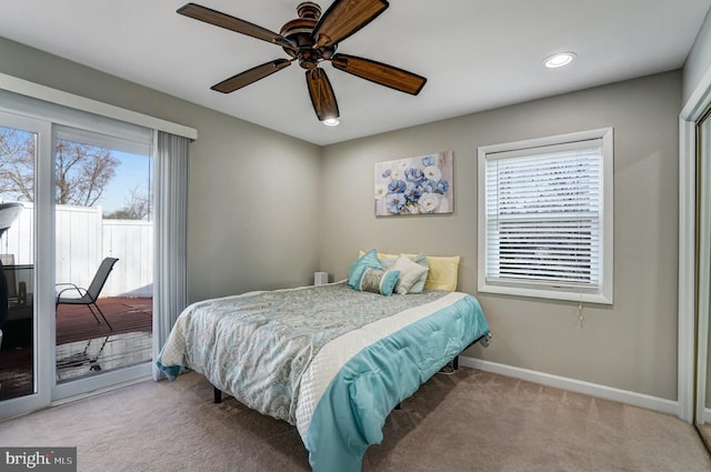 bedroom with access to outside, multiple windows, carpet, and baseboards