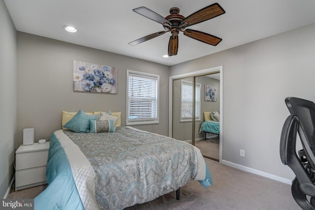 bedroom with baseboards, carpet floors, a closet, and a ceiling fan