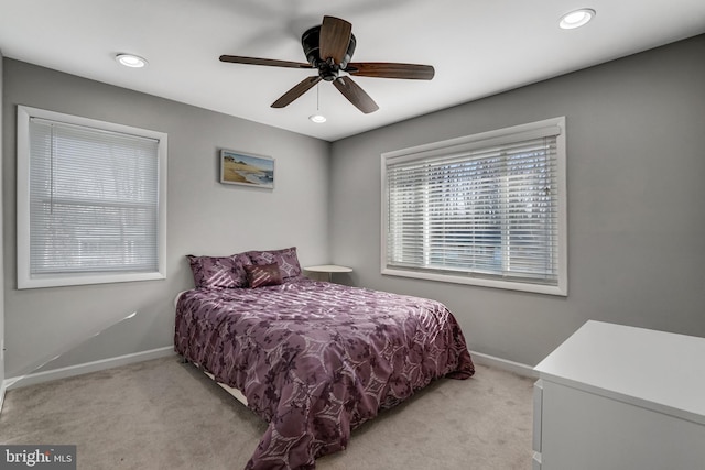 bedroom with a ceiling fan, recessed lighting, baseboards, and light carpet