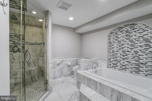 bathroom with visible vents, toilet, a garden tub, tile walls, and a shower stall