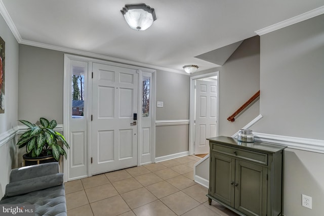 foyer with crown molding, light tile patterned flooring, and baseboards