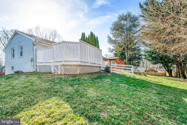 view of yard with a wooden deck and fence