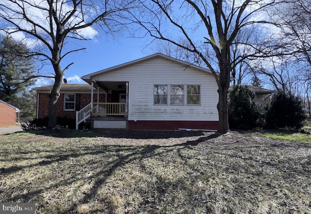 view of front of home with covered porch and brick siding