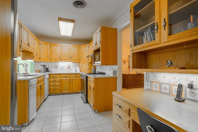 kitchen featuring light tile patterned floors, visible vents, a sink, light countertops, and appliances with stainless steel finishes