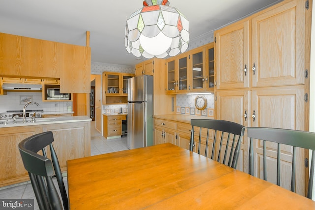 dining space with light tile patterned floors and wallpapered walls