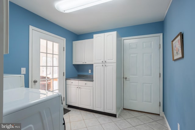 washroom with light tile patterned floors and cabinet space