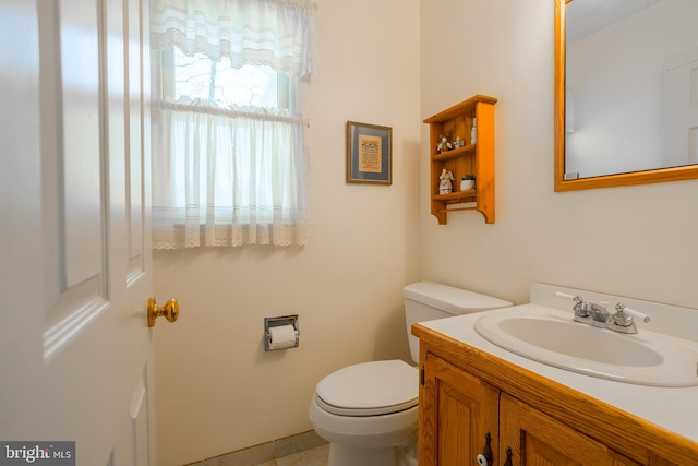 half bathroom featuring toilet and vanity