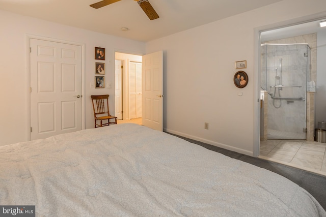 tiled bedroom with ceiling fan, ensuite bath, and baseboards