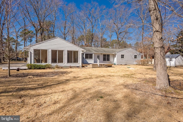 back of property with entry steps, dirt driveway, a storage shed, an outdoor structure, and crawl space