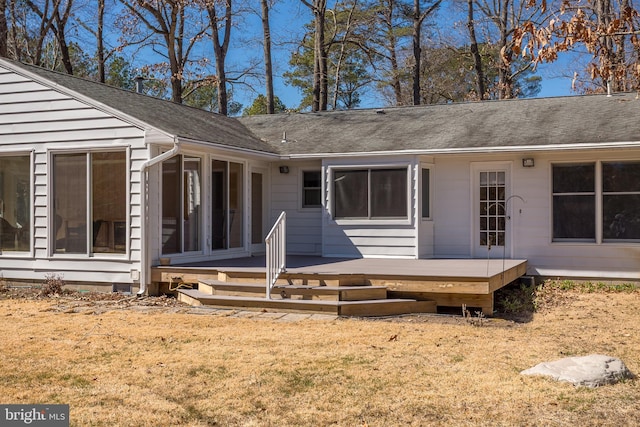 entrance to property with a yard and a deck