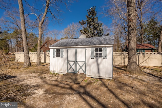 view of shed with fence