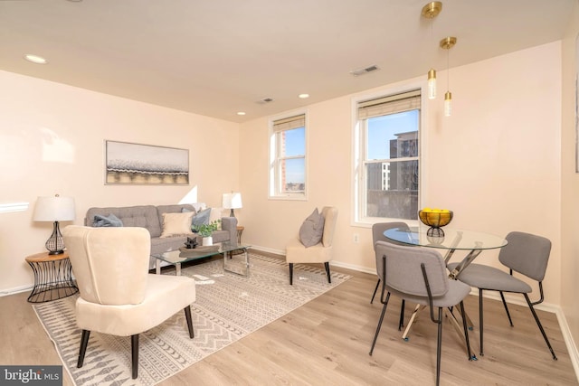 living room featuring recessed lighting, wood finished floors, and baseboards