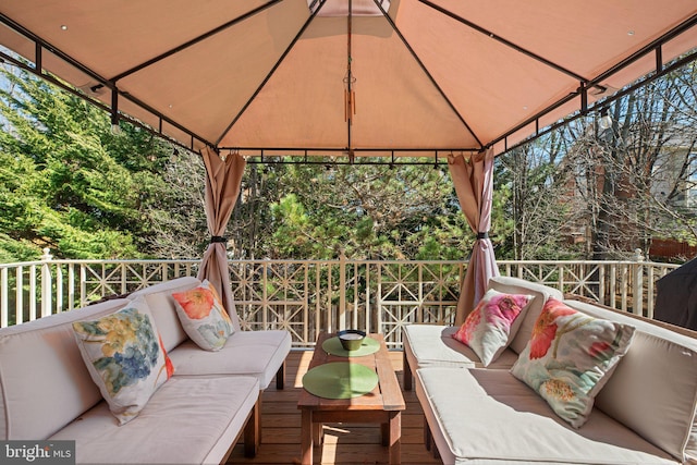 wooden terrace featuring a gazebo and an outdoor hangout area