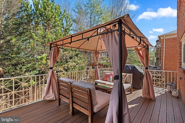 wooden terrace with a gazebo and outdoor lounge area