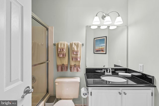 bathroom featuring vanity, toilet, and shower / bath combination with glass door