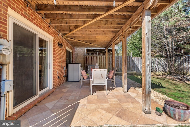 view of patio with outdoor dining space and fence