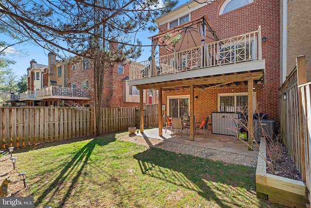 rear view of house featuring brick siding, central AC, a fenced backyard, and a lawn