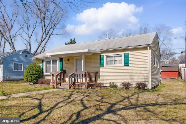 bungalow-style home with a front yard and a porch