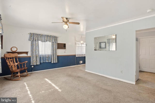 living room featuring carpet flooring, baseboards, crown molding, and ceiling fan