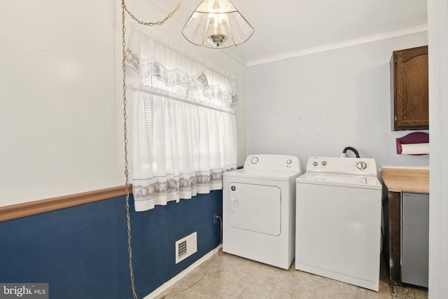 laundry room with visible vents, ornamental molding, laundry area, and washer and clothes dryer