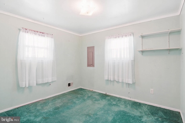 carpeted empty room featuring crown molding, electric panel, visible vents, and baseboards