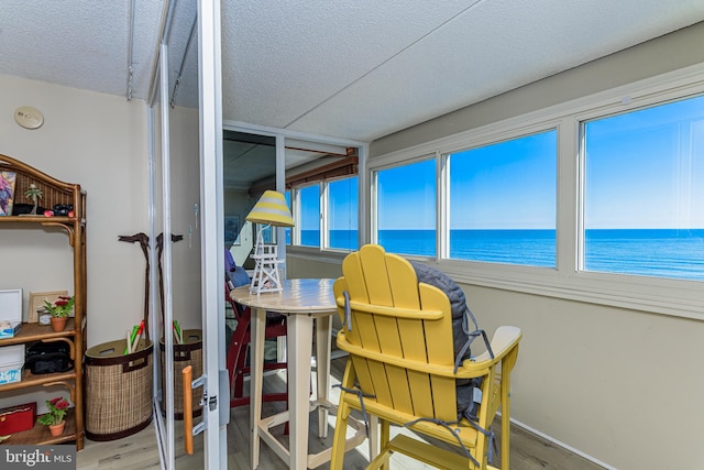 sunroom / solarium with a water view