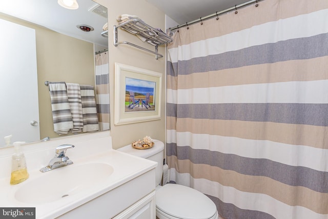 bathroom with visible vents, toilet, vanity, and a shower with curtain