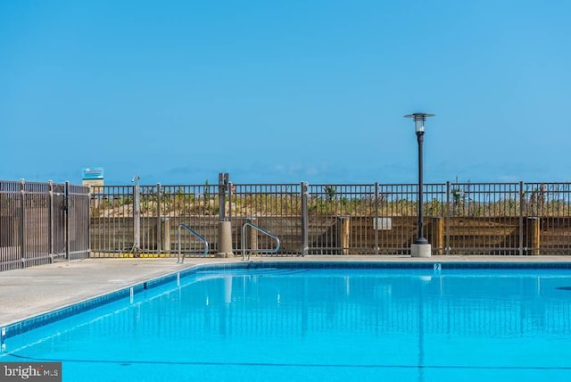 community pool featuring fence