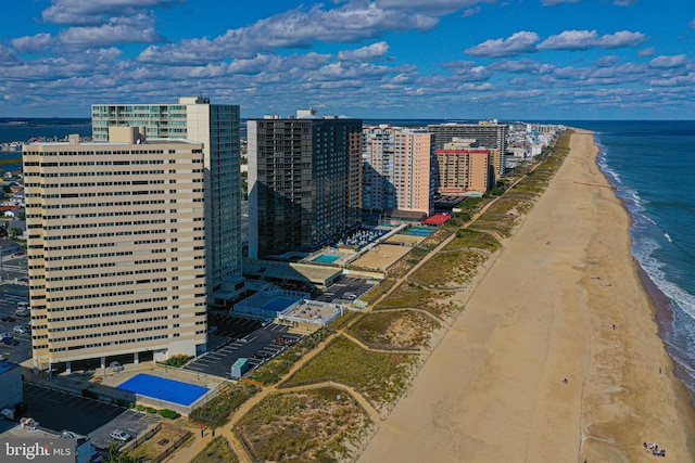 bird's eye view featuring a water view, a view of city, and a beach view