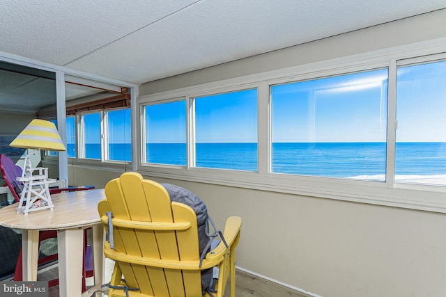 sunroom / solarium with a healthy amount of sunlight and a water view