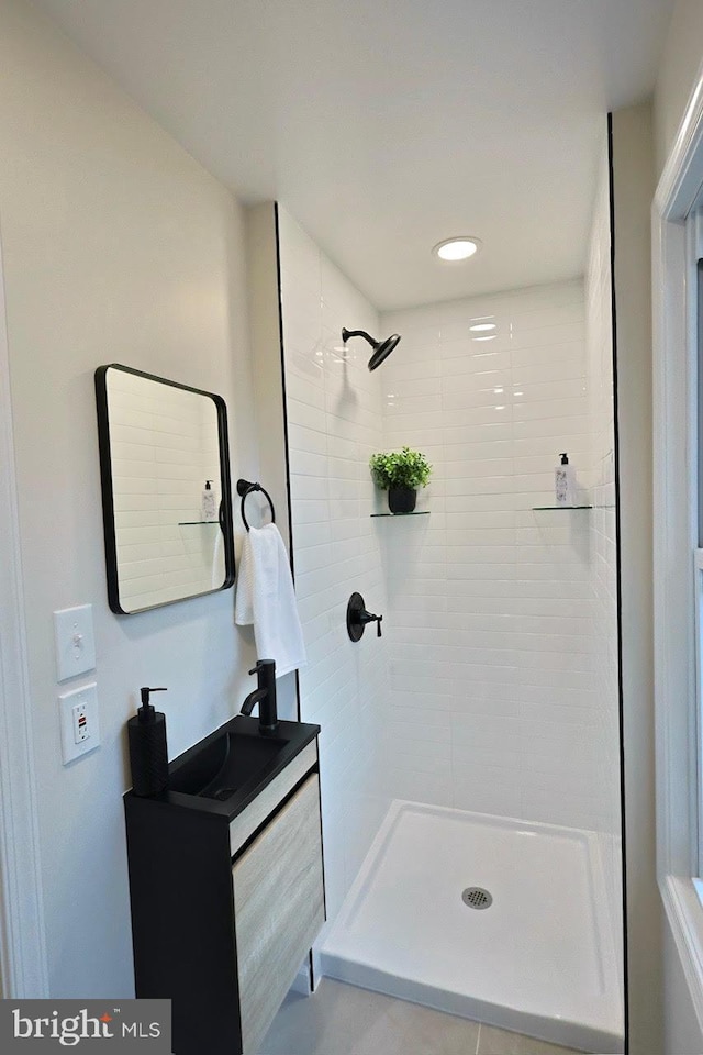 bathroom featuring vanity and a tile shower