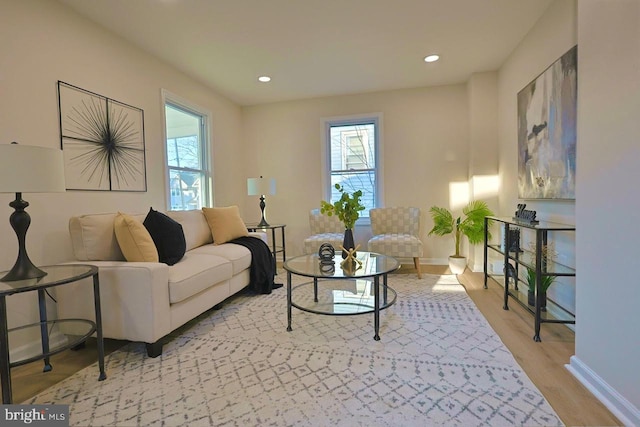 living room featuring recessed lighting, baseboards, and light wood-style floors