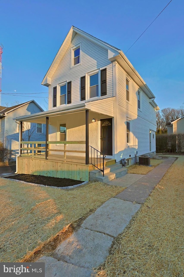 view of front facade featuring entry steps, a porch, and central air condition unit