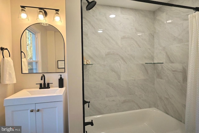 bathroom featuring vanity and shower / bath combination with curtain