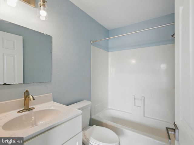 bathroom with vanity, shower / bathing tub combination, and toilet