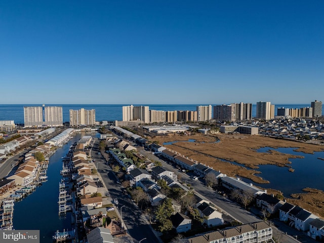 drone / aerial view with a city view and a water view