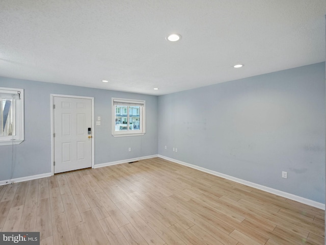 interior space with recessed lighting, baseboards, and light wood finished floors