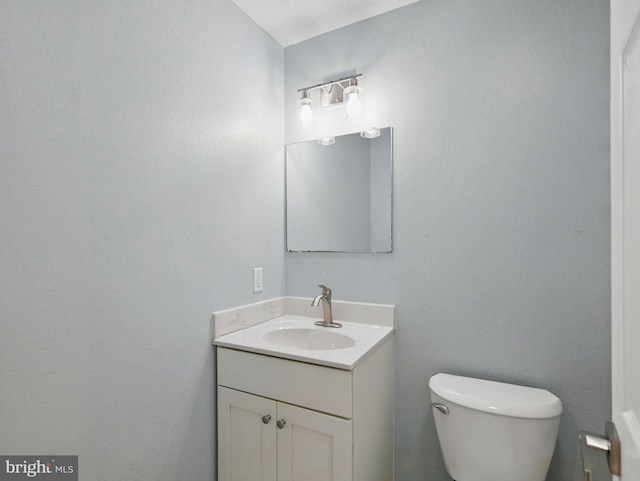 bathroom with toilet and vanity