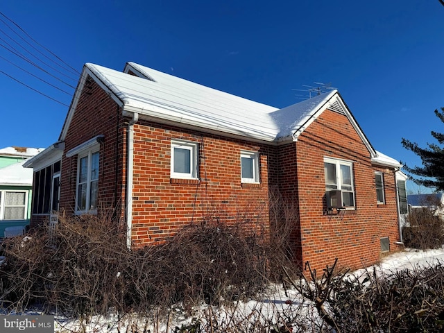 view of side of home featuring brick siding