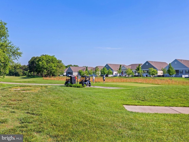 view of home's community featuring a residential view and a yard