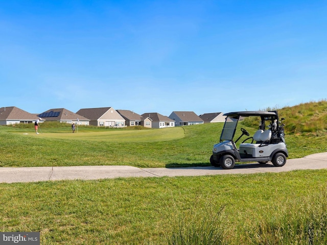 surrounding community with a yard and a residential view