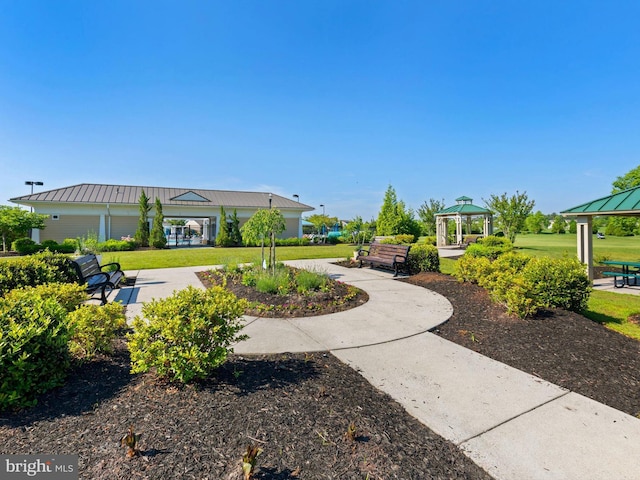 view of property's community with a gazebo and a yard