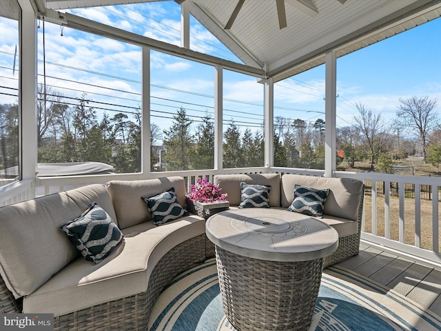 sunroom / solarium with vaulted ceiling and a ceiling fan