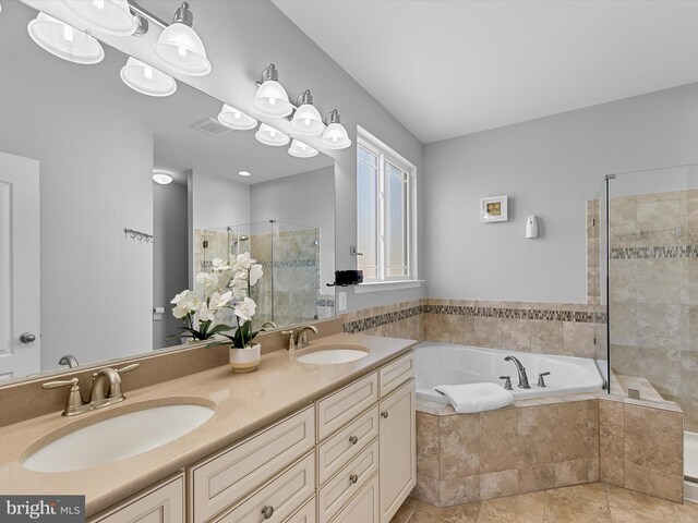 bathroom with a shower stall, a garden tub, visible vents, and a sink